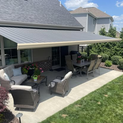 retractable canvas awning installed over concrete patio in customers back yard by Country Canvas awnings