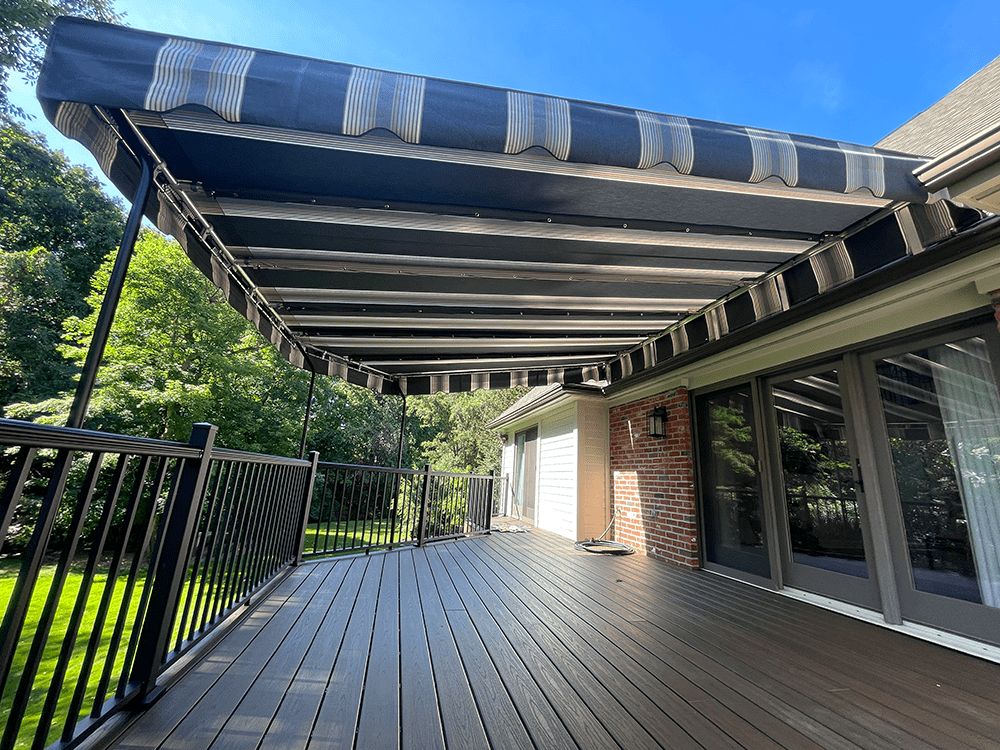 striped canvasa wning over a composite deck, installed in Pittsburgh