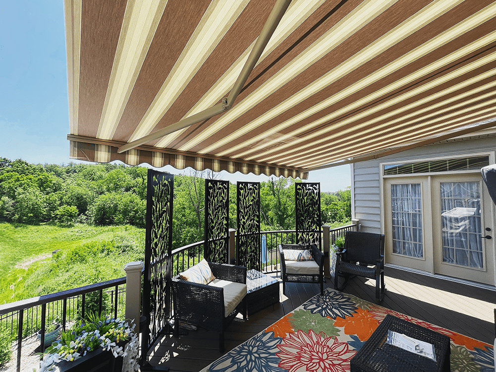 tan striped retractable awning on a balcony deck viewed from underneith