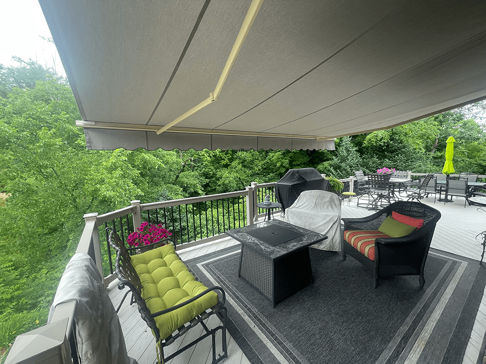 tan retractable canvas awning on a deck