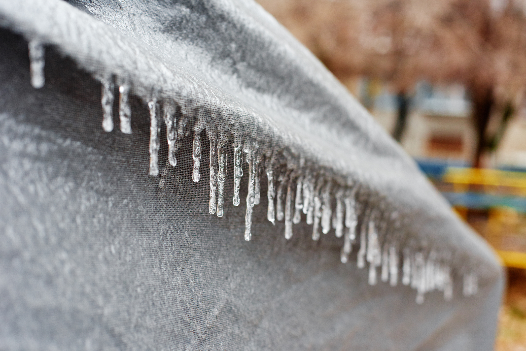 snow and ice on a canvas awning