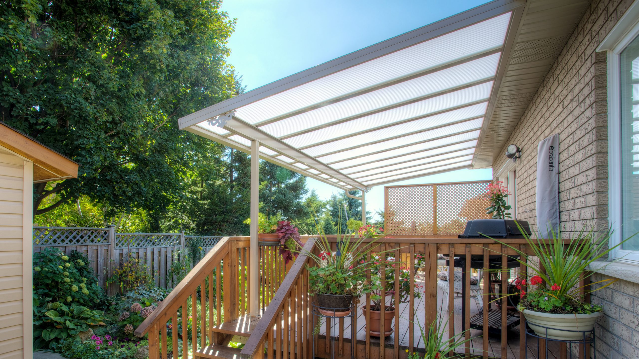 clear acrylic patio cover installed on deck behind pittsburgh home by country canvas